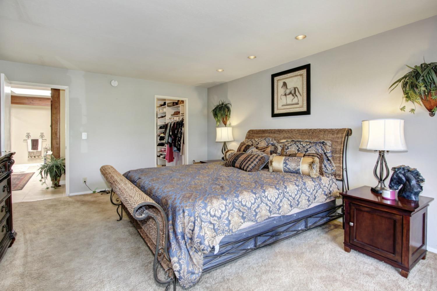 18119 Norlene Way Grass Valley, CA 95949 - Photo 46 of 93 a bedroom with a bed and a lamp on table