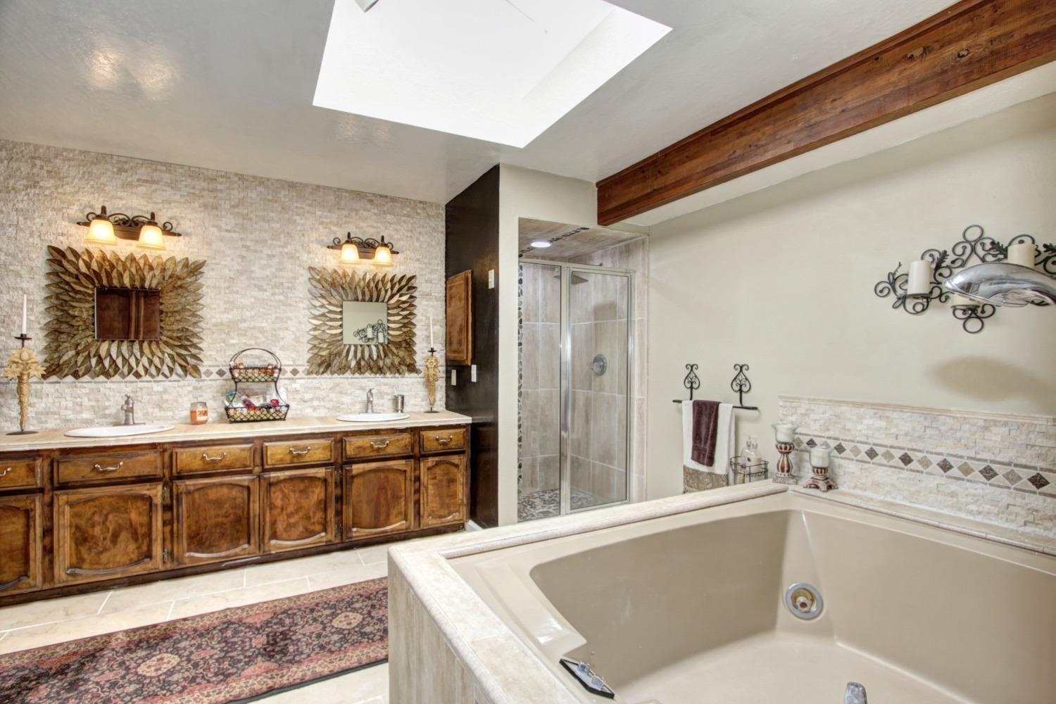 18119 Norlene Way Grass Valley, CA 95949 - Photo 47 of 93 a bathroom with a tub sink and mirror