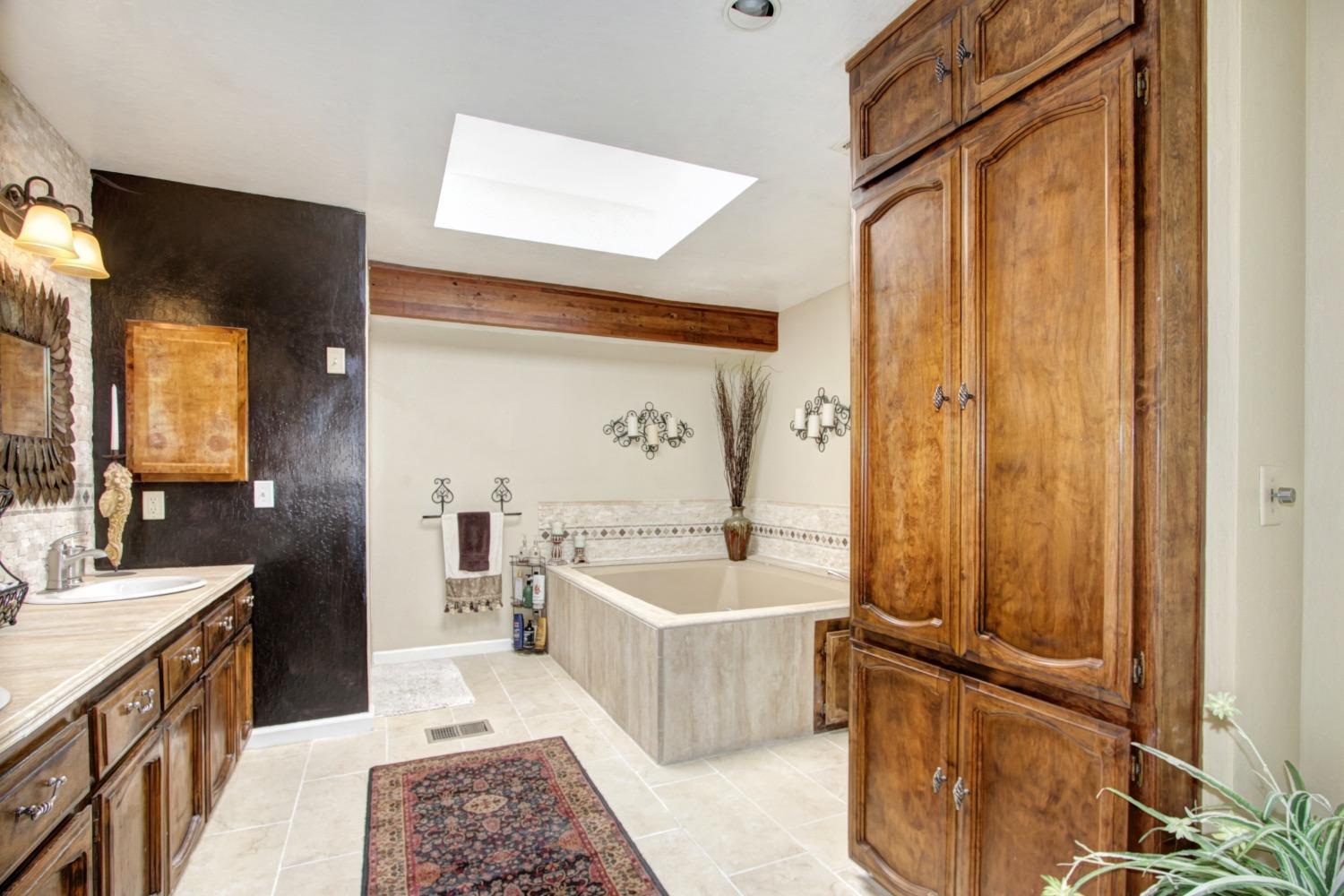 18119 Norlene Way Grass Valley, CA 95949 - Photo 52 of 93 a large bathroom with a tub a sink and mirrors