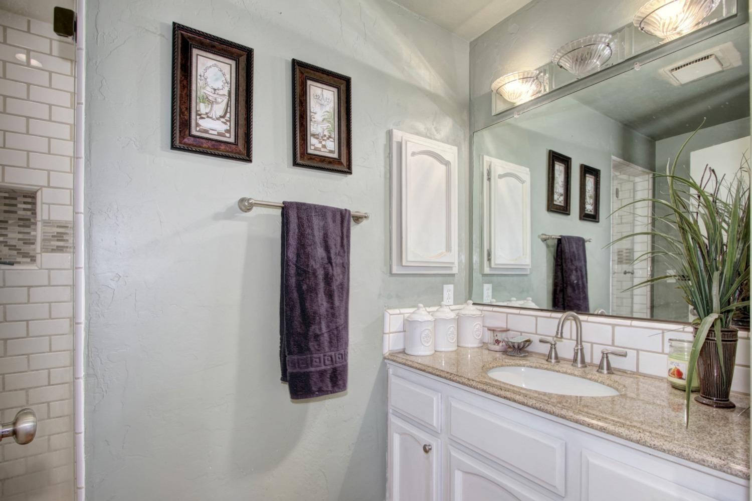 18119 Norlene Way Grass Valley, CA 95949 - Photo 56 of 93 a bathroom with a granite countertop sink and a mirror