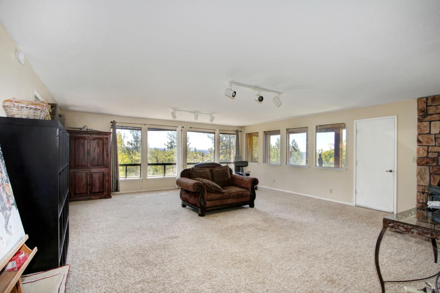 18119 Norlene Way Grass Valley, CA 95949 - Photo 59 of 93 a living room with furniture window and a flat screen tv