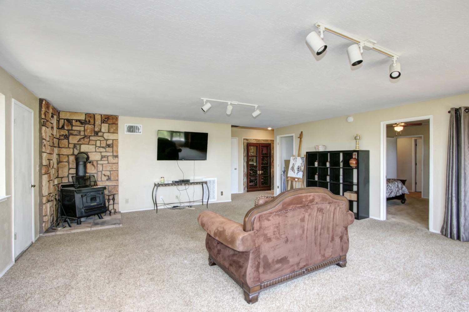 18119 Norlene Way Grass Valley, CA 95949 - Photo 62 of 93 a living room with furniture and a flat screen tv