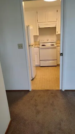 a view of kitchen with granite countertop cabinets and sink