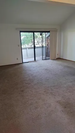a view of an empty room with a fireplace