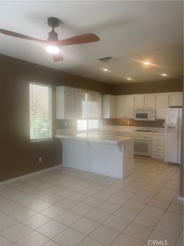a view of an empty room with wooden floor and window