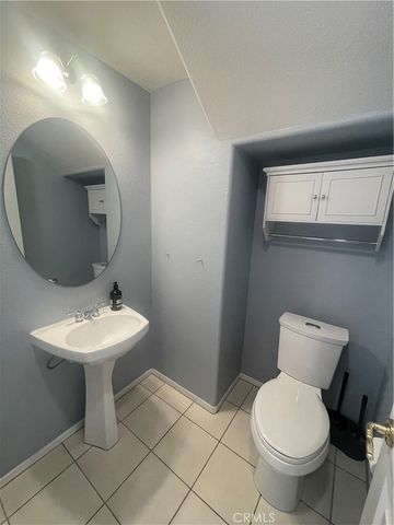 a bathroom with a toilet a sink and a large mirror