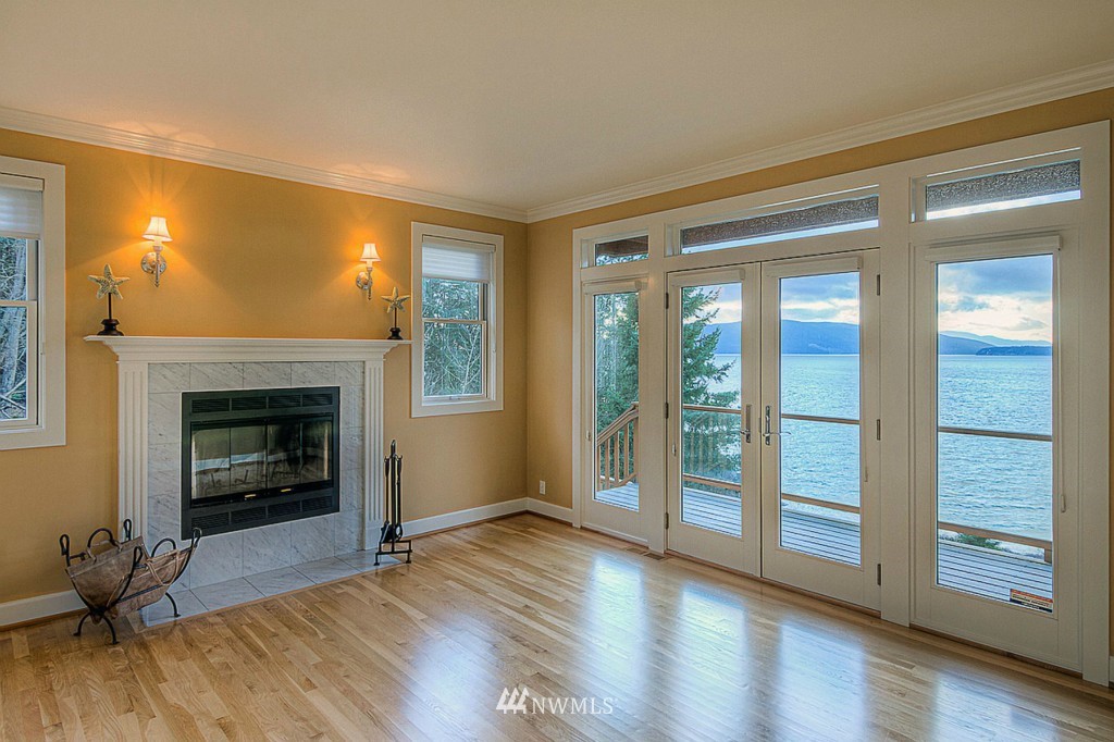 804 Fieldston Road Bellingham, WA 98225 - Photo 11 of 25 a view of an empty room with wooden floor fireplace and a window