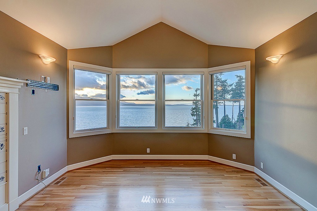 804 Fieldston Road Bellingham, WA 98225 - Photo 14 of 25 a view of an empty room with a window and wooden floor