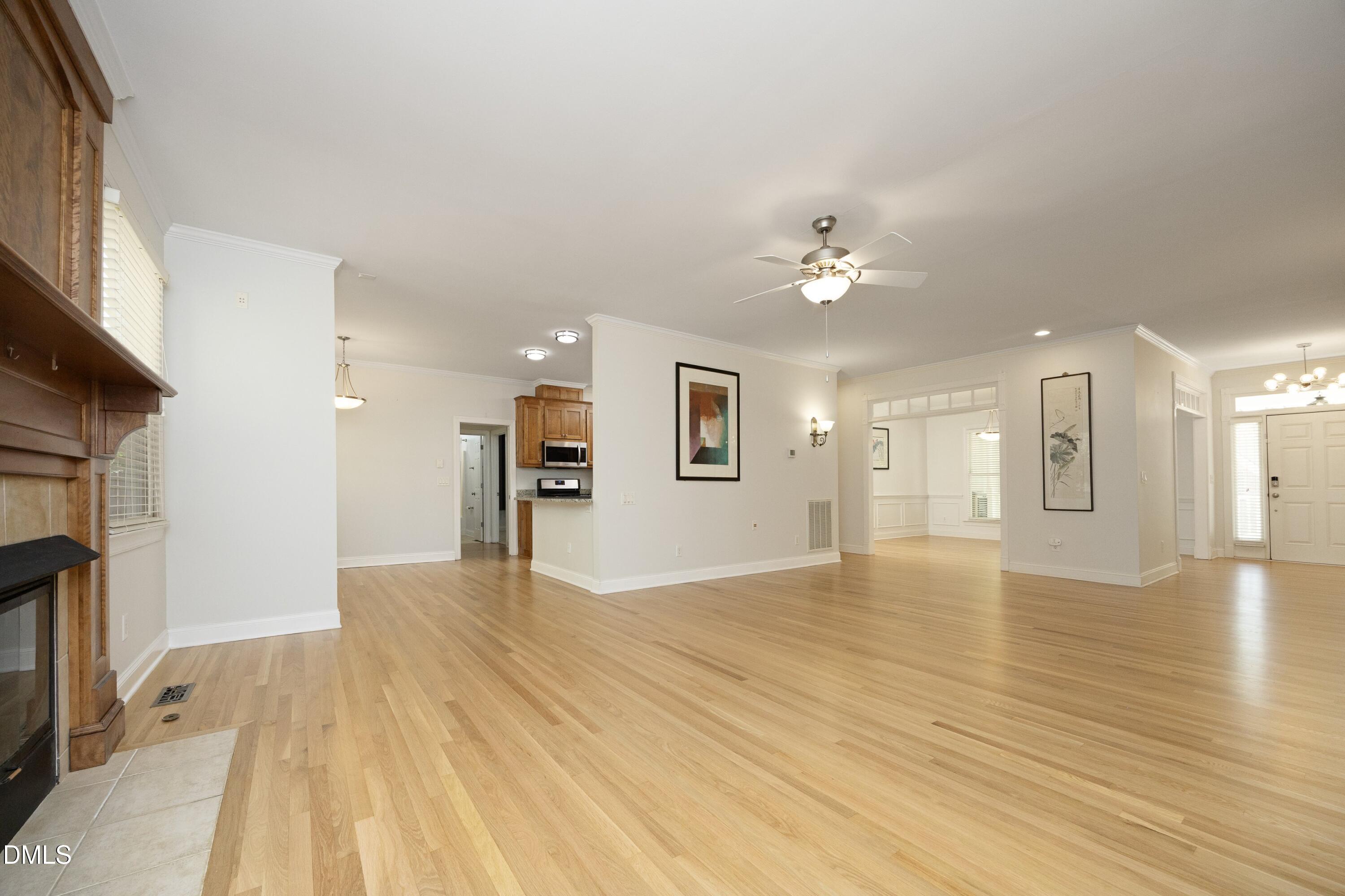 1427 Moosecreek Drive Raleigh, NC 27614 - Photo 11 of 51 a view of a livingroom with a ceiling fan window a ceiling fan and wooden floor