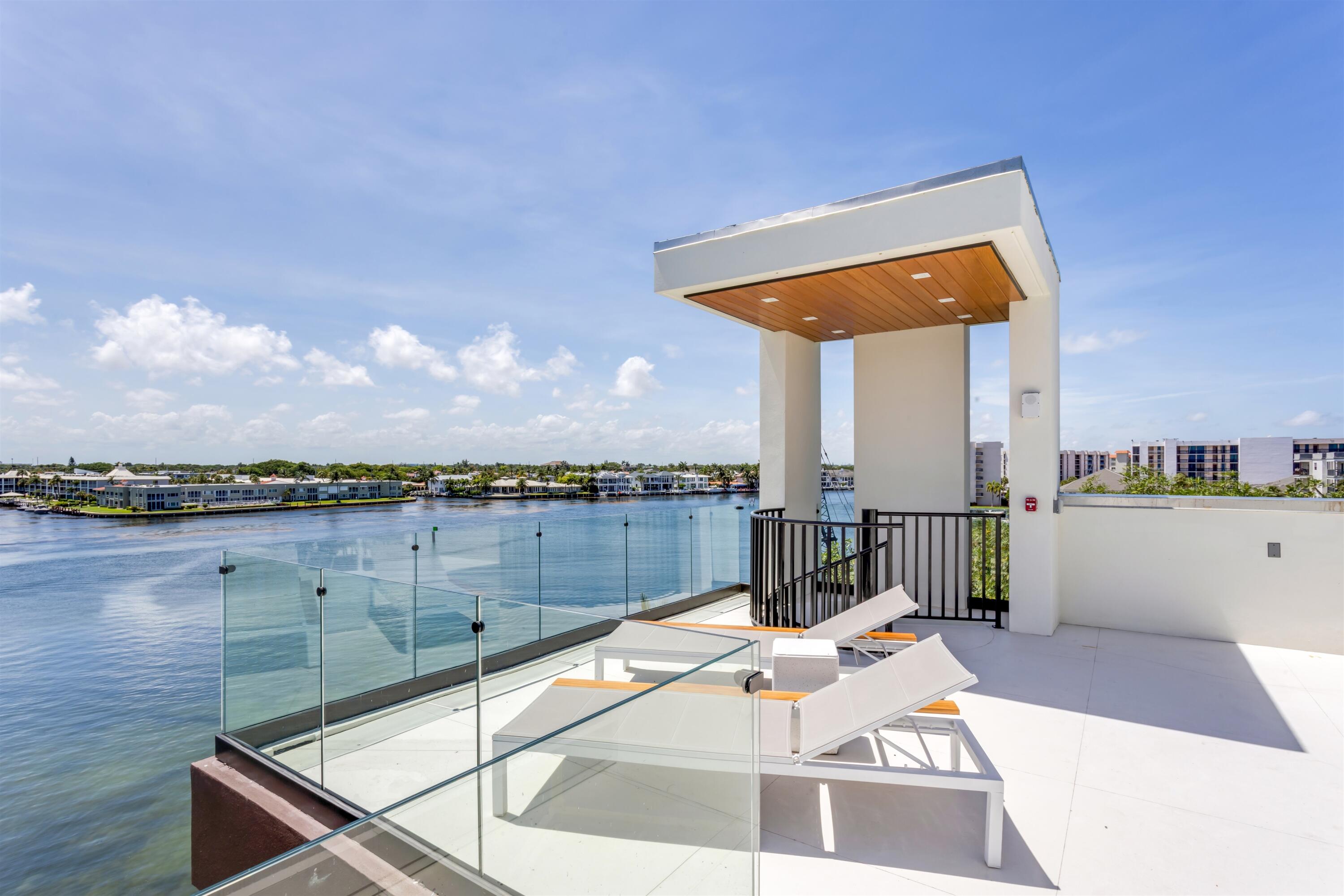 900 Lago Mar Lane, Unit PH Boca Raton, FL 33431 - Photo 38 of 58 a view of a terrace with couches and city view