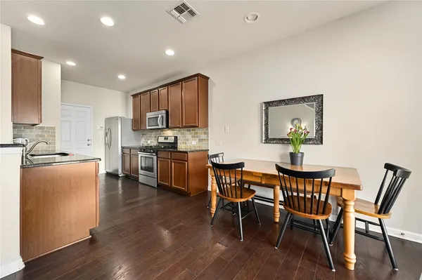 a view of kitchen with cabinets table and chairs