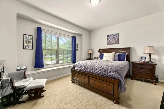 a spacious bedroom with a bed and a window