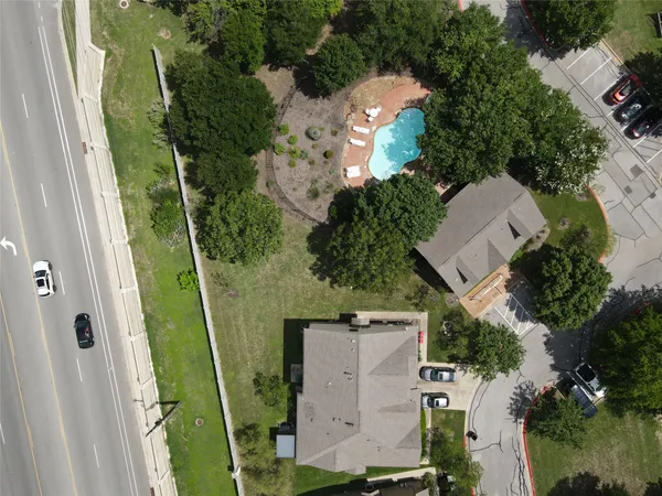 an aerial view of a house with a yard and outdoor seating