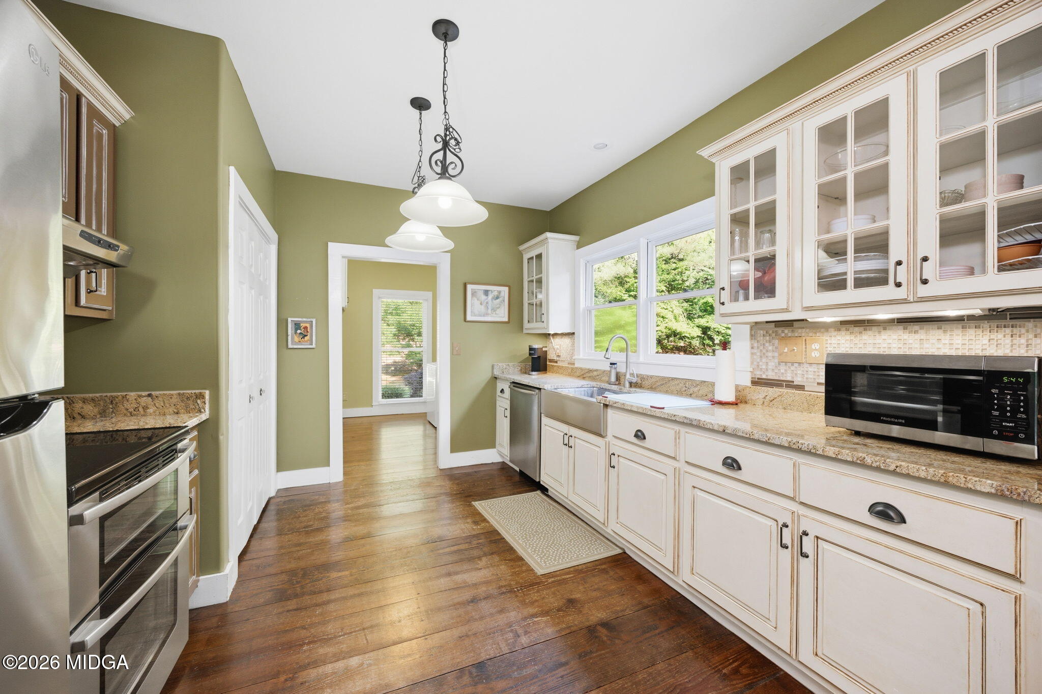 4686 Johnstonville Road Forsyth, GA 31029 - Photo 11 of 34 a large kitchen with granite countertop a stove and a sink