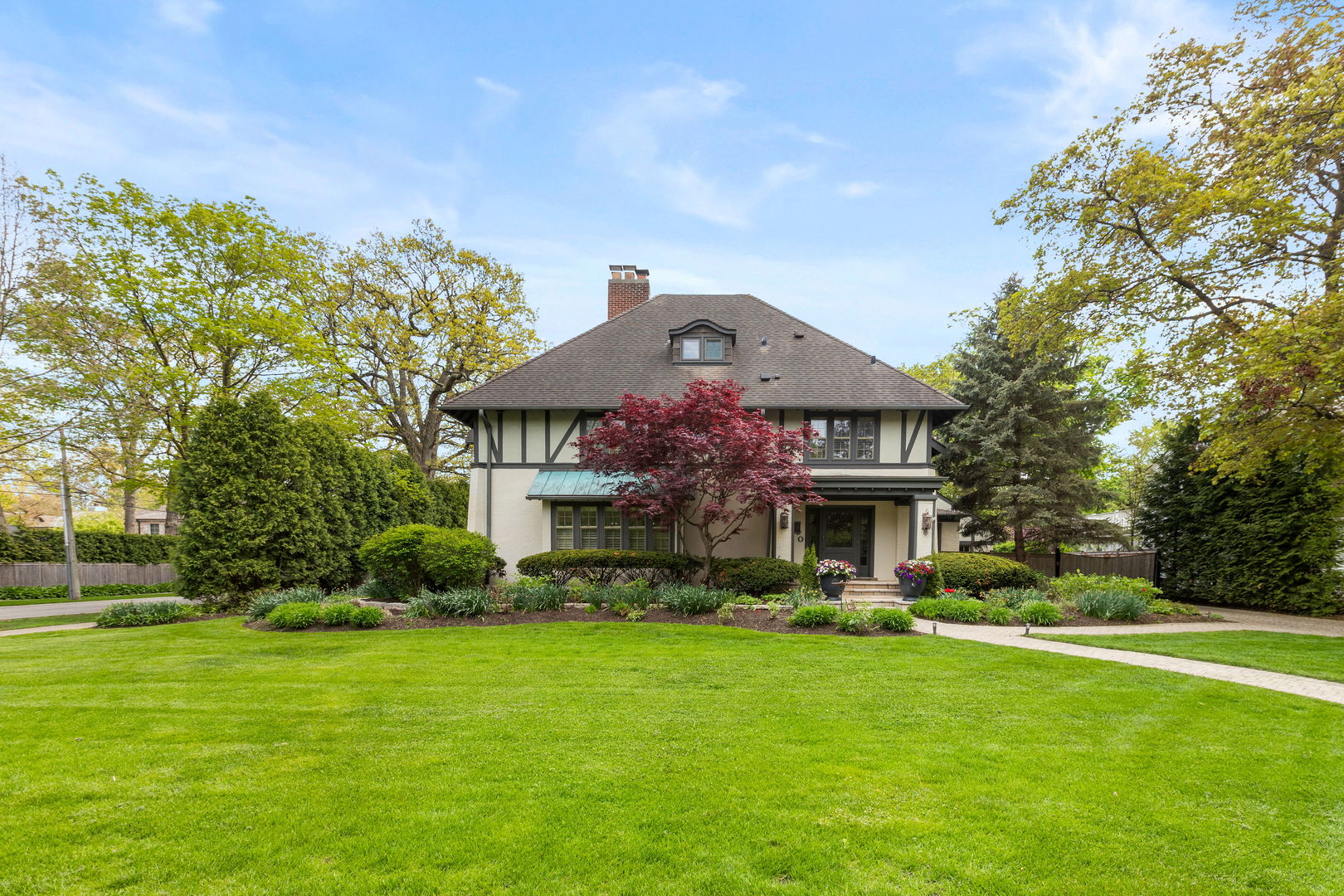 600 Ash Street Winnetka, IL 60093 - Photo 1 of 30 a front view of a house with a garden