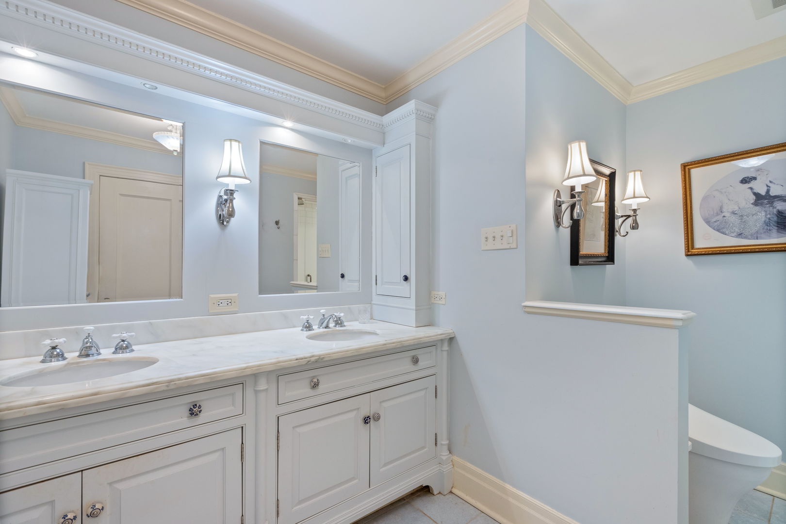 600 Ash Street Winnetka, IL 60093 - Photo 15 of 30 a bathroom with a double vanity sink and a mirror