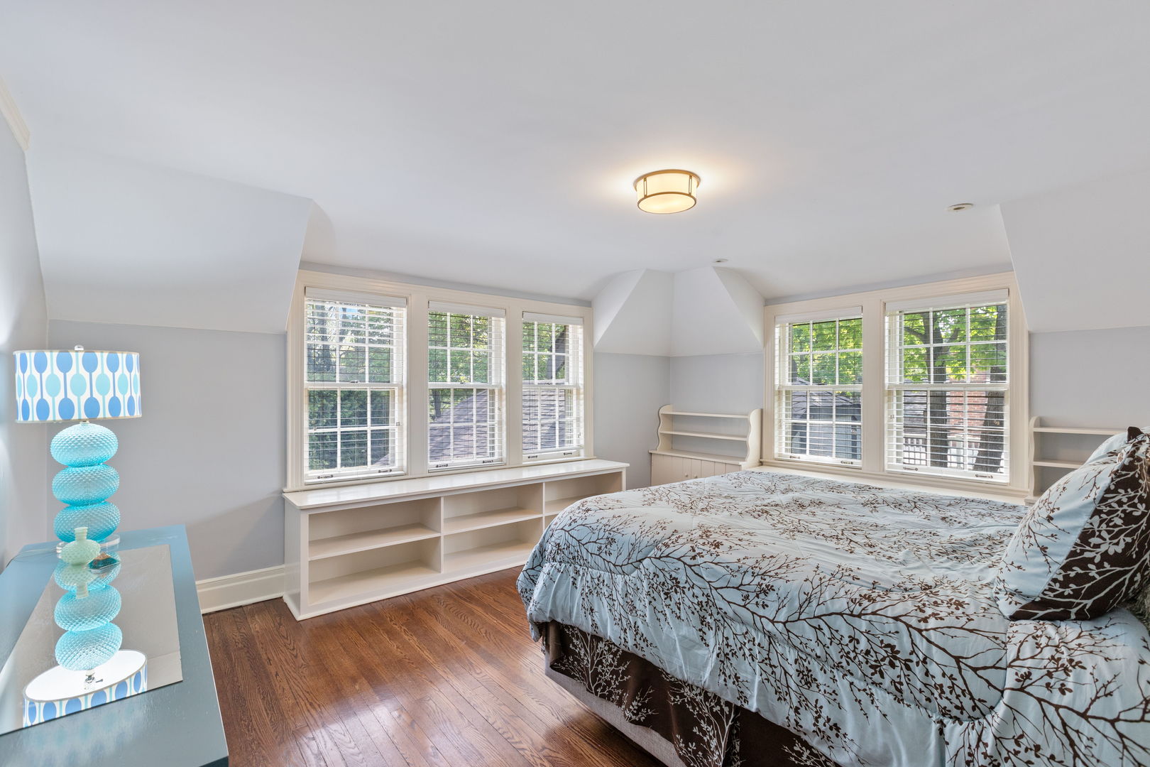 600 Ash Street Winnetka, IL 60093 - Photo 18 of 30 a bedroom with a bed and wooden floor