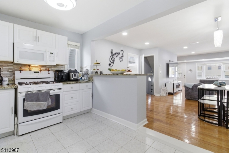 32 Cedar Avenue Elizabeth, NJ 07202 - Photo 6 of 32 a kitchen with stainless steel appliances granite countertop a stove a sink and a microwave