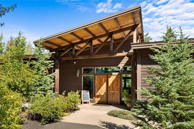 a view of backyard with outdoor seating and plants