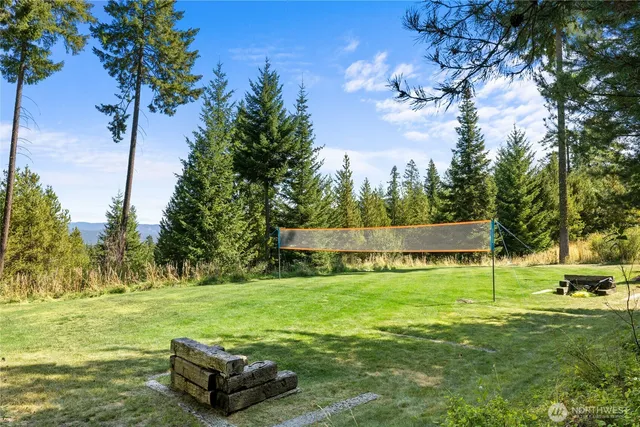 a living room with furniture a fireplace and a floor to ceiling window