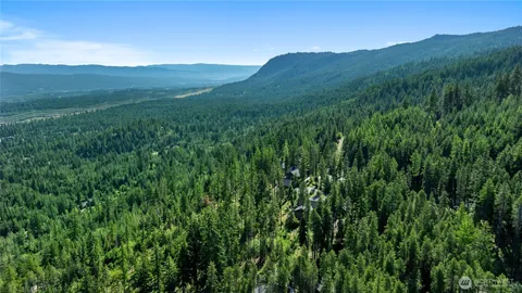 a view of a lush green hillside and a building in the background