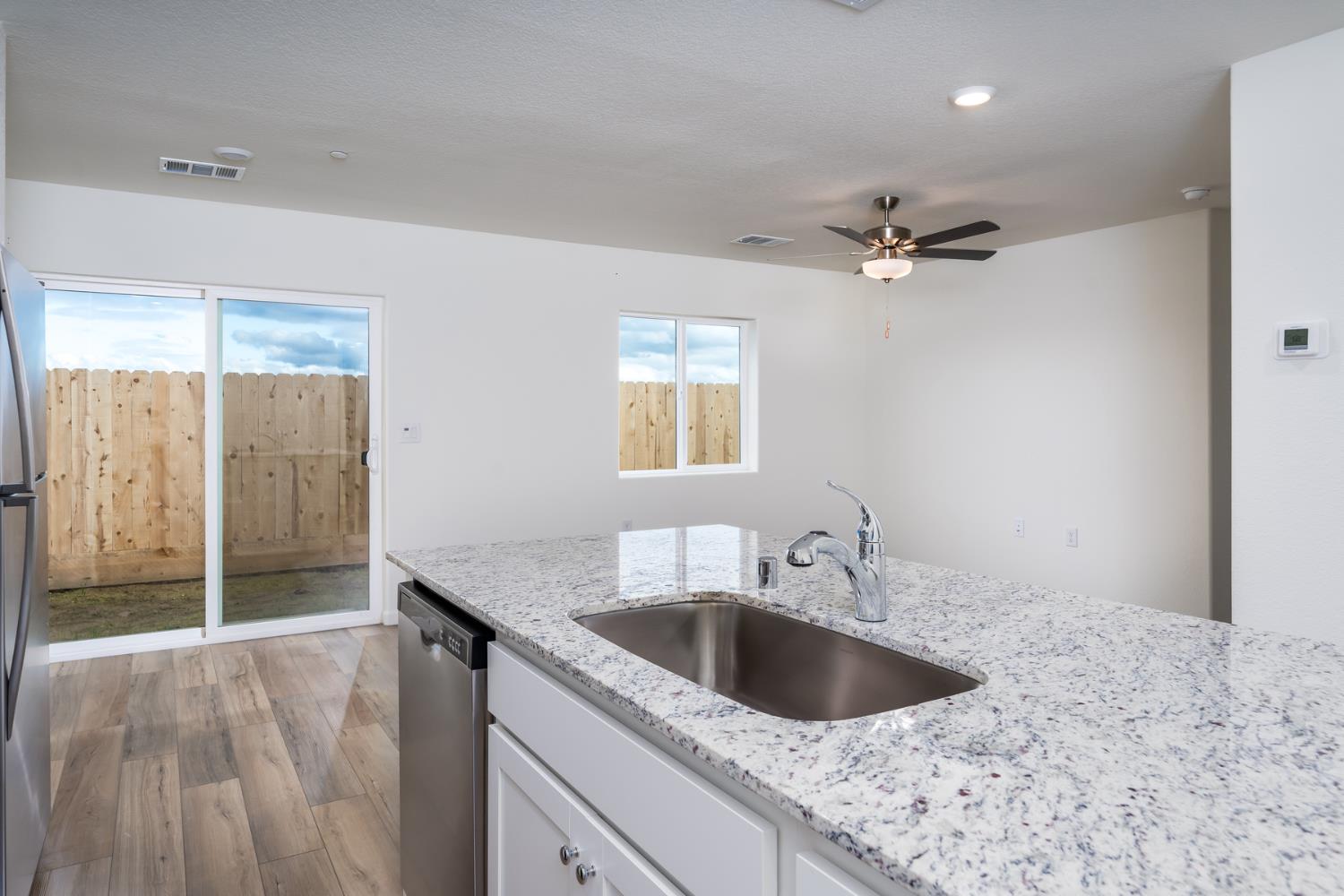 2265 Travis Court Newman, CA 95360 - Photo 5 of 12 a kitchen with a sink and a refrigerator