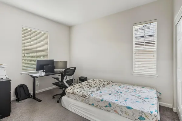 a bedroom with a workspace