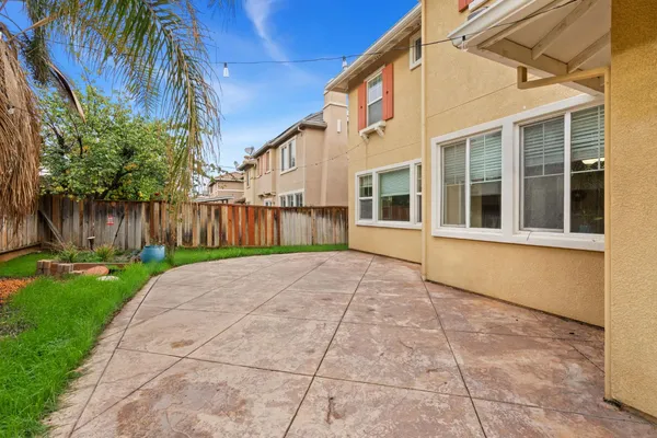 a view of a house with backyard and wooden fence