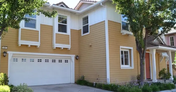 a view of a house with a tree