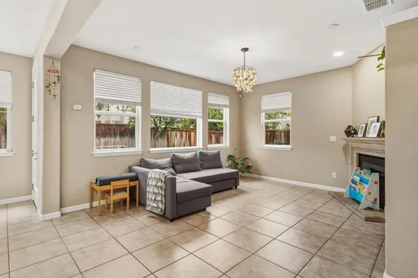 a living room with furniture and a chandelier