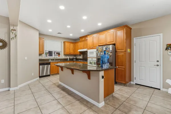 a kitchen with stainless steel appliances granite countertop a stove and a refrigerator