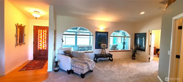 a living room with furniture a large window and a flat screen tv