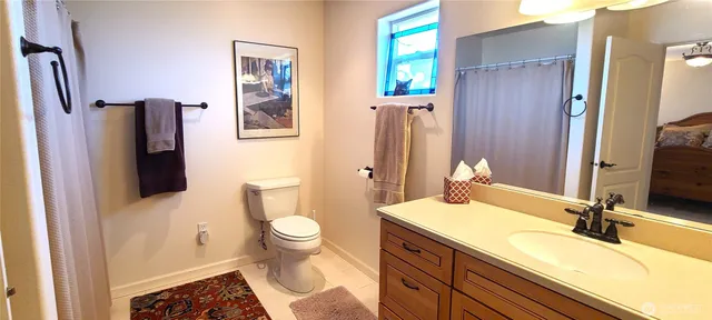 a bathroom with a sink mirror and vanity