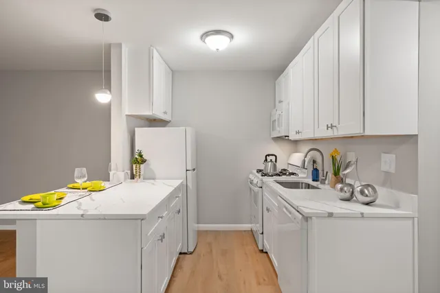 a kitchen that has a sink and a stove in it