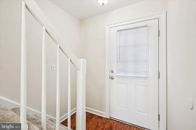a view of an entryway with wooden floor