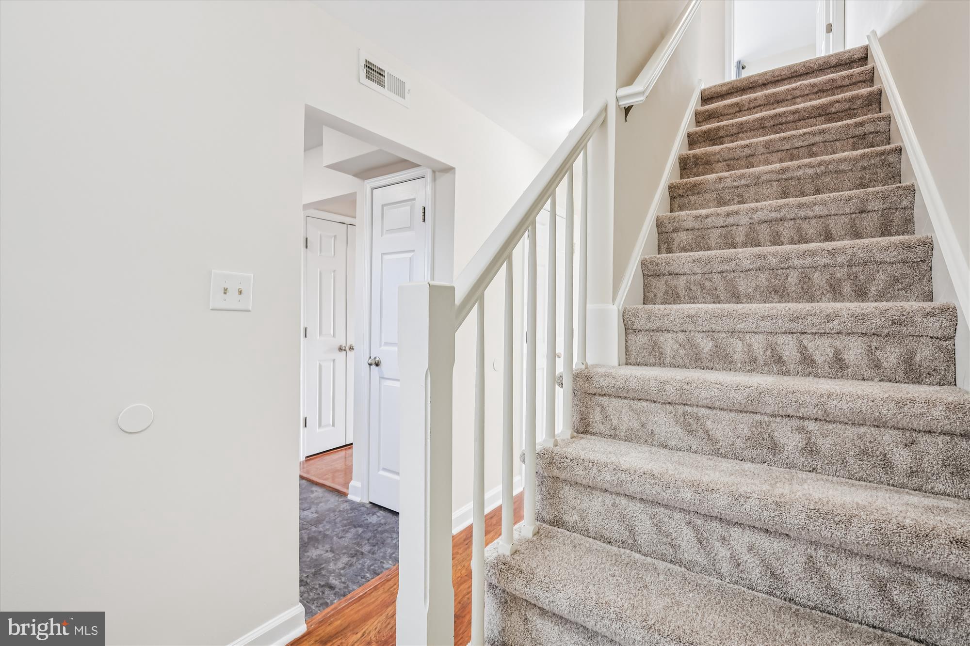 209 Webb Lane St. Michaels, MD 21663 - Photo 19 of 33 a view of staircase with white walls and white door