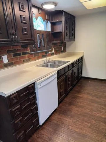 a kitchen with stainless steel appliances granite countertop a sink and a stove