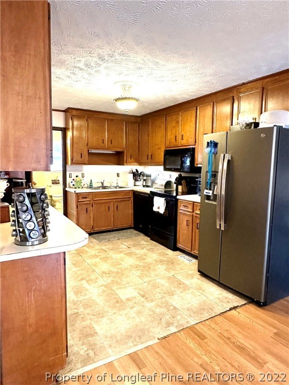 1597 Wade-Stedman Road Stedman, NC 28391 - Photo 21 of 25 a kitchen with granite countertop a sink counter top space appliances and cabinets