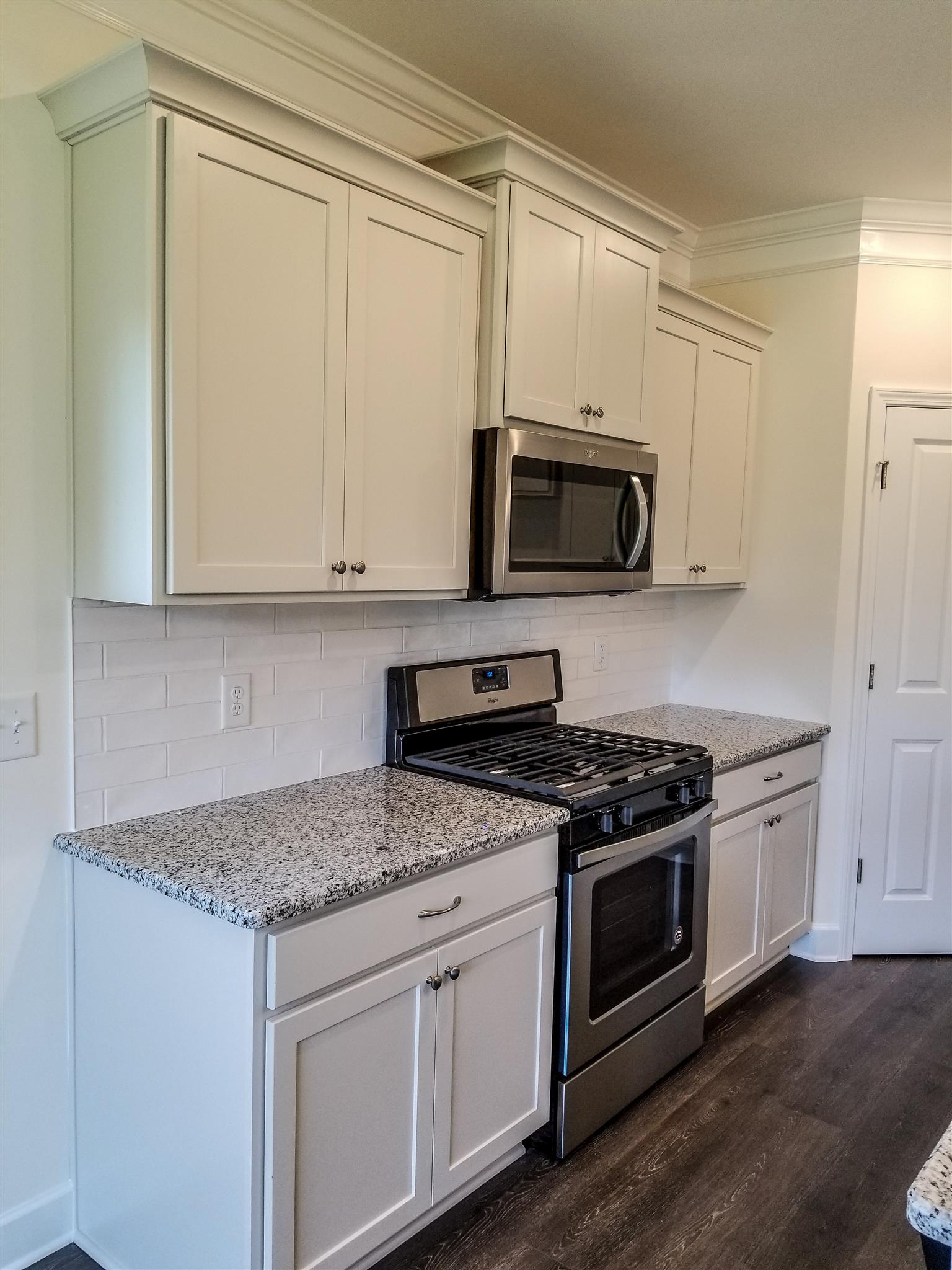 403 Butler Road Mount Juliet, TN 37122 - Photo 7 of 24 a kitchen with stainless steel appliances granite countertop a stove microwave and cabinets