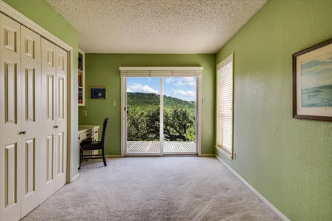 a view of a room with a large window and a hallway