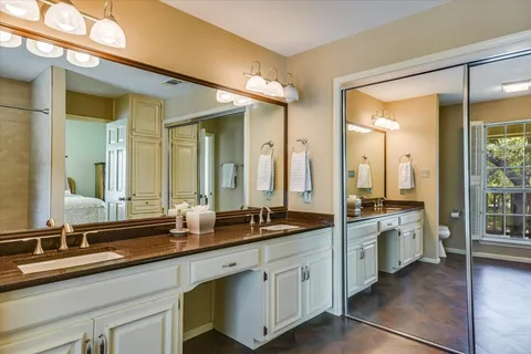 a large bathroom with double sink and a large mirror