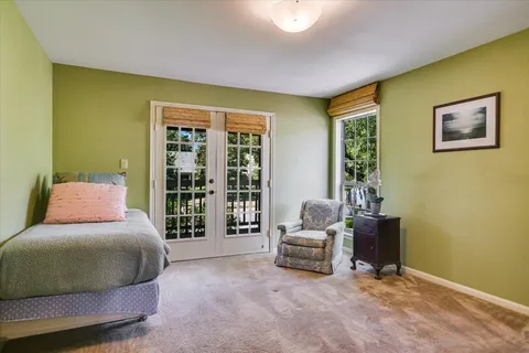 a bedroom with furniture and a window