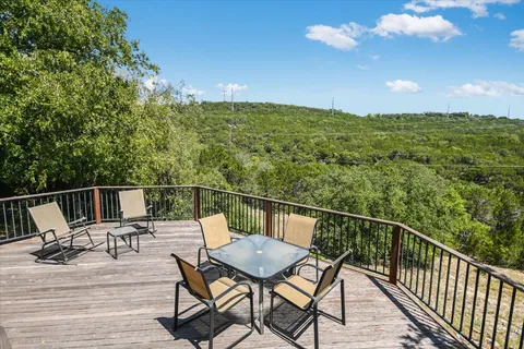 a view of a balcony with furniture and wooden floor