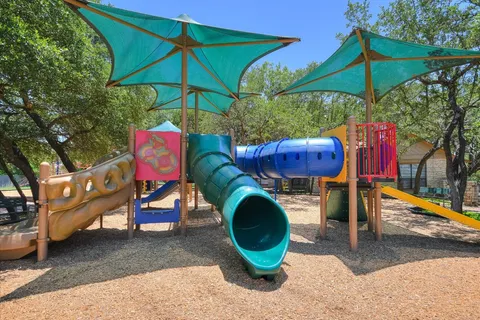 a view of a patio with a table and chairs under an umbrella