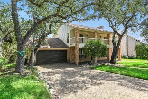 a house that has a tree in front of the house