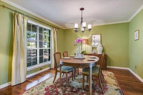 a view of a dining room with furniture wooden floor and chandelier