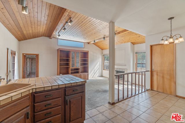a view of a hallway with an entryway and livingroom