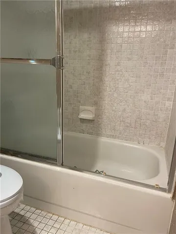 a bathroom with a bathtub and a toilet