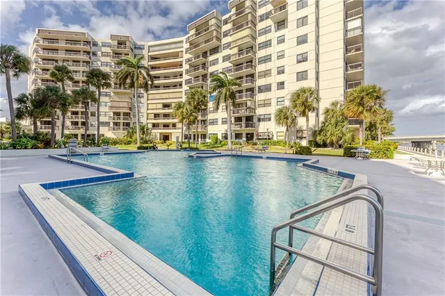 swimming pool with outdoor seating and city view