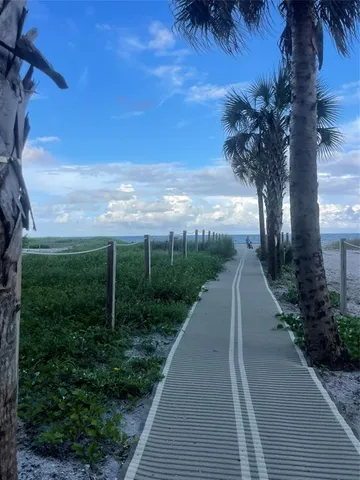 a view of a patio with dining table and chairs under an umbrella